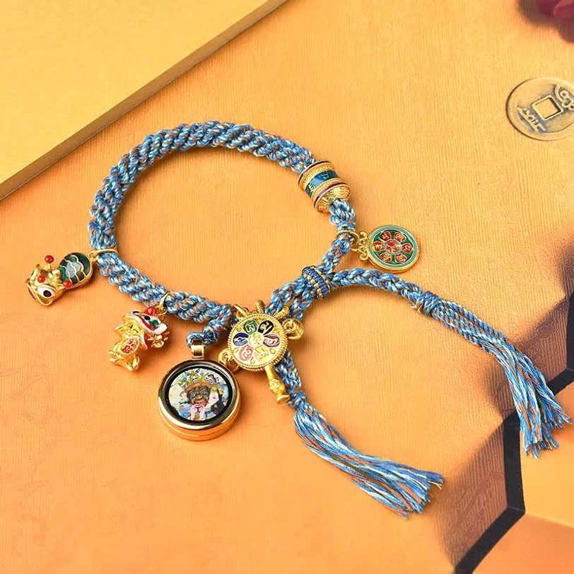 Tibetan blessing bracelet with enamel ornaments and lion dance charm on warm cardboard background