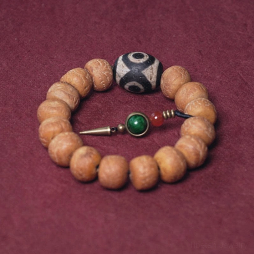 Spread-out bodhi seed dzi bead mala bracelet set with three-eyed dzi focal bead and pendant on wine-red background