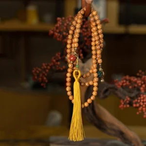 Tibetan 108 bodhi seed prayer mala hanging display showing natural bead texture and mustard tassel