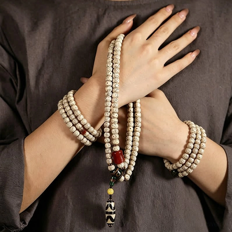 Tibetan bodhi mala bracelet worn on hands, multiple strands showing as wearable Bodhi necklace with Dzi pendant