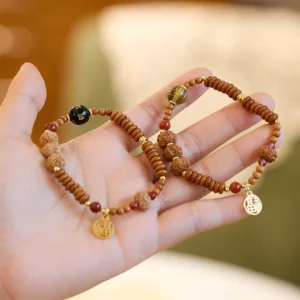 Tibetan bodhi seed bracelet set with black onyx Om Mani Padme Hum and gold Fu character charm, overhead flat lay view