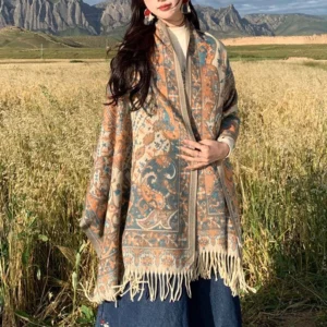 Woman wearing bohemian tibetan printed shawl with floral pattern on mountain grassland background