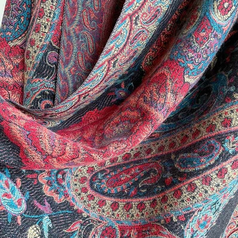 Tibetan bohemian shawl with mixed warm tones, intricate jacquard pattern showing artisan craftsmanship