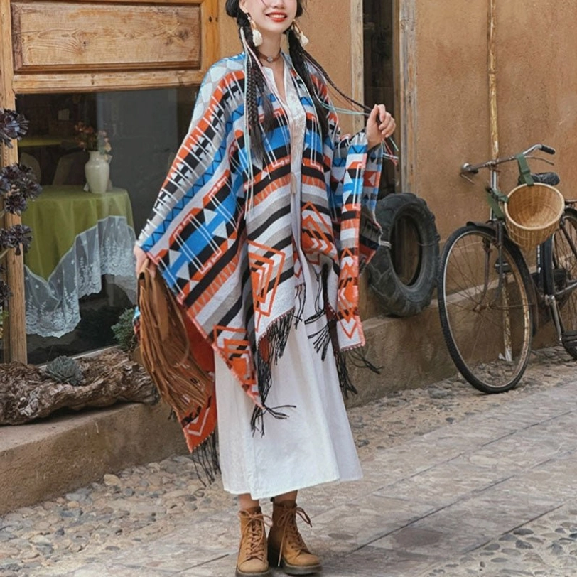 Bohemian tassel shawl styled with white linen dress, outdoor street setting, colorful geometric tribal motifs