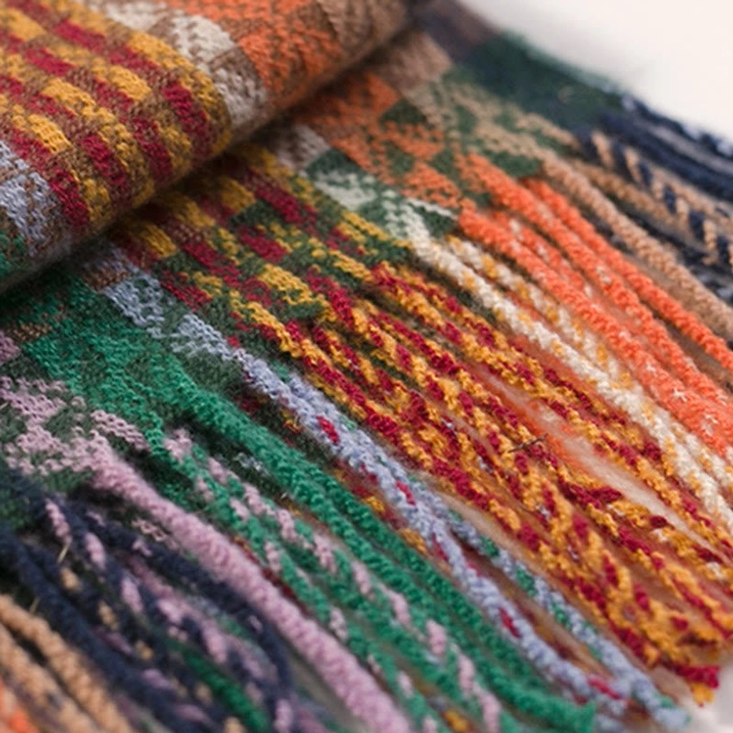 Tibetan bohemian shawl with tassels displayed on natural background emphasizing artisanal quality