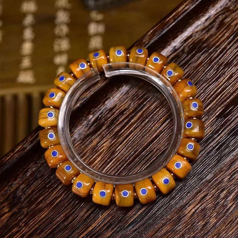 Tibetan bone bead bracelet A Style displayed on clear ring stand with calligraphy background