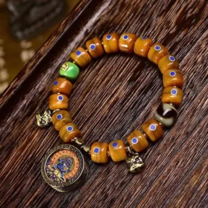 Tibetan bone bead bracelet with Lazurite and Copper accents, flat lay view on dark wooden surface