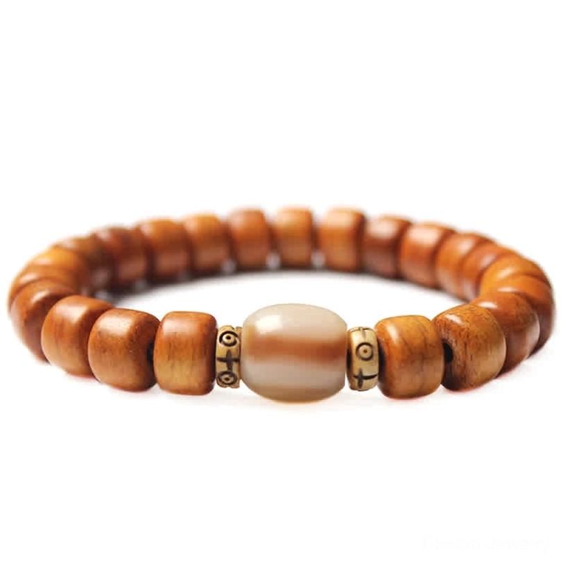 Minimalist Tibetan bone bead bracelet with light brown barrel beads and small metal spacers on gray background