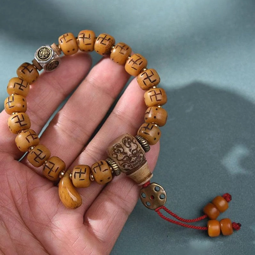 Tibetan bone bead bracelet with multiple spiritual charms and protective symbols - authentic nomadic heritage jewelry