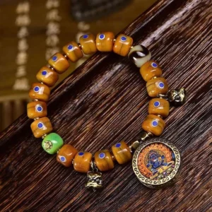 Handmade Tibetan spiritual bracelet with brown barrel beads and blue Lazurite stone, overhead view