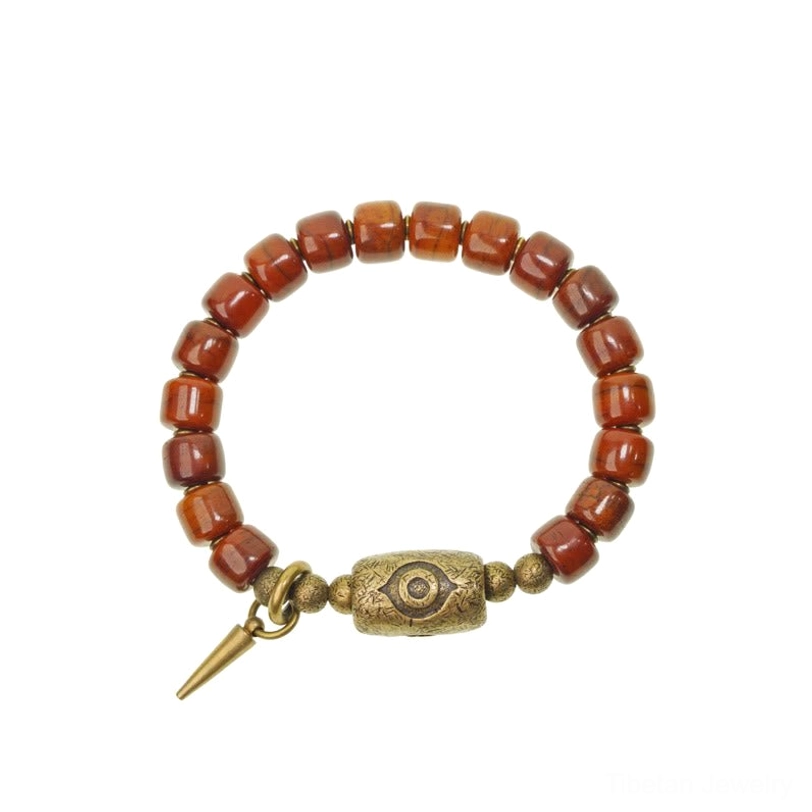 Complete Tibetan bone Dzi bracelet with cone pendant featuring copper charm and protective eye symbol for spiritual wellness