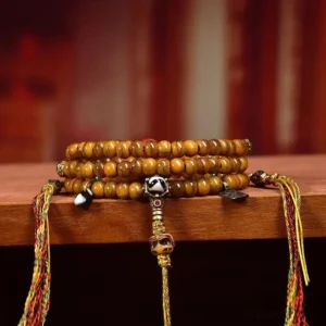 Stacked Tibetan prayer bead malas with colorful tassel accents and metal counter beads - side perspective