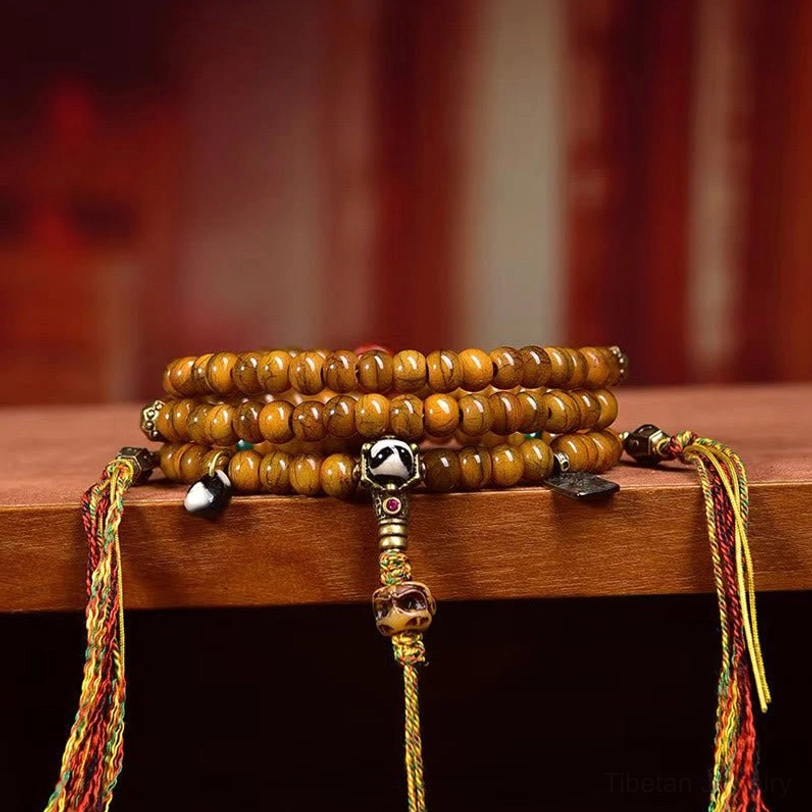Stacked Tibetan prayer bead malas with colorful tassel accents and metal counter beads - side perspective