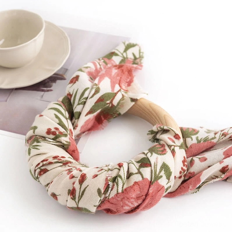 Tibetan floral fabric hair accessory made from the same soft botanical print material, twisted design detail