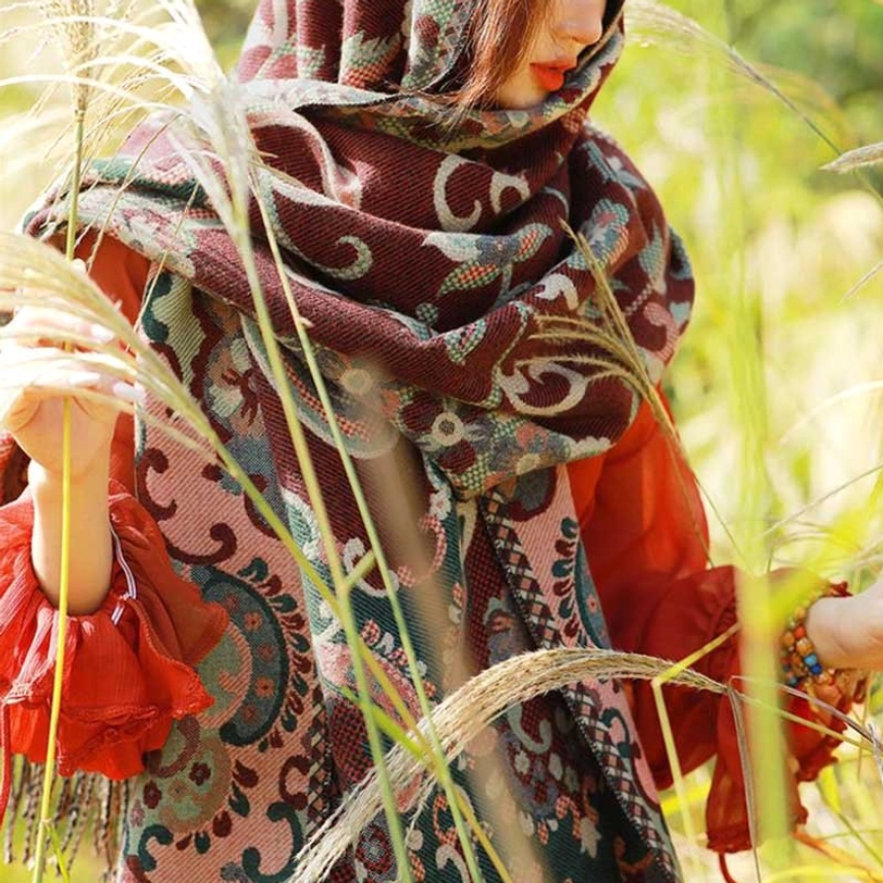 Hooded Tibetan botanical tassel shawl with thick woven fabric covering head and shoulders in outdoor reed setting