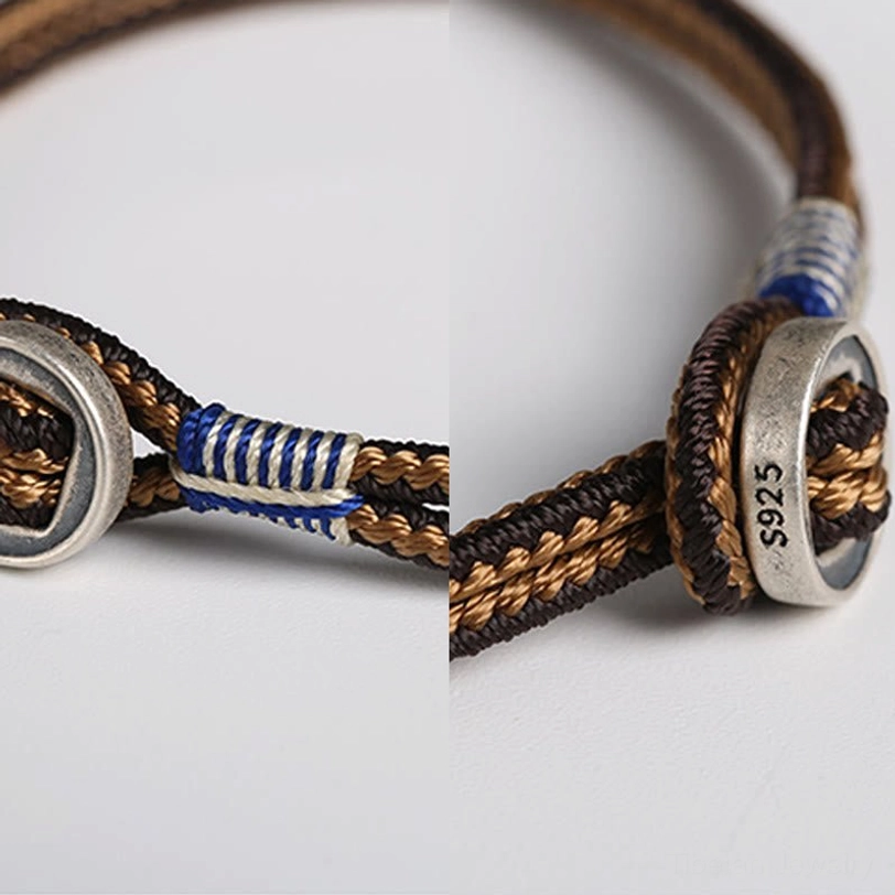 Extreme close-up of 925 sterling silver clasp with S925 hallmark on handwoven tibetan protection bracelet cord ends