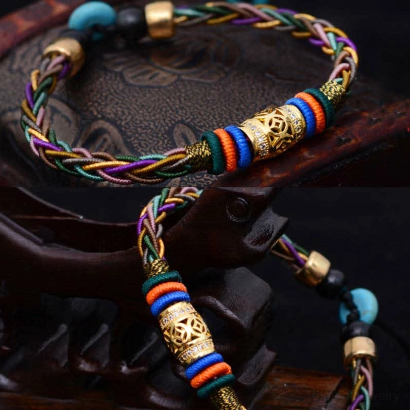 Tibetan protection bracelet top-down view on carved wood box with hanging adjustable cord, turquoise bead accents, and woven design