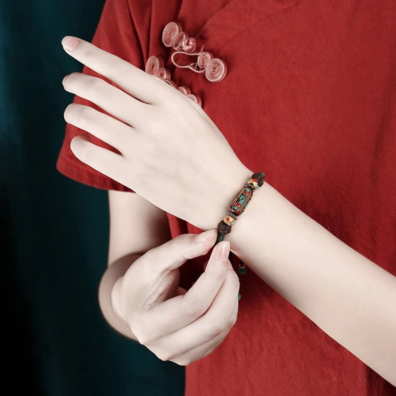 Tibetan braided bracelet showing adjustable sizing mechanism and wrist circumference fit guide