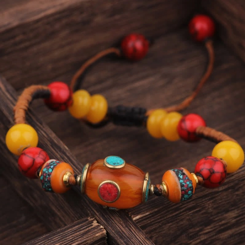 Black orange braided rope Tibetan bracelet with amber center bead and red yellow beads