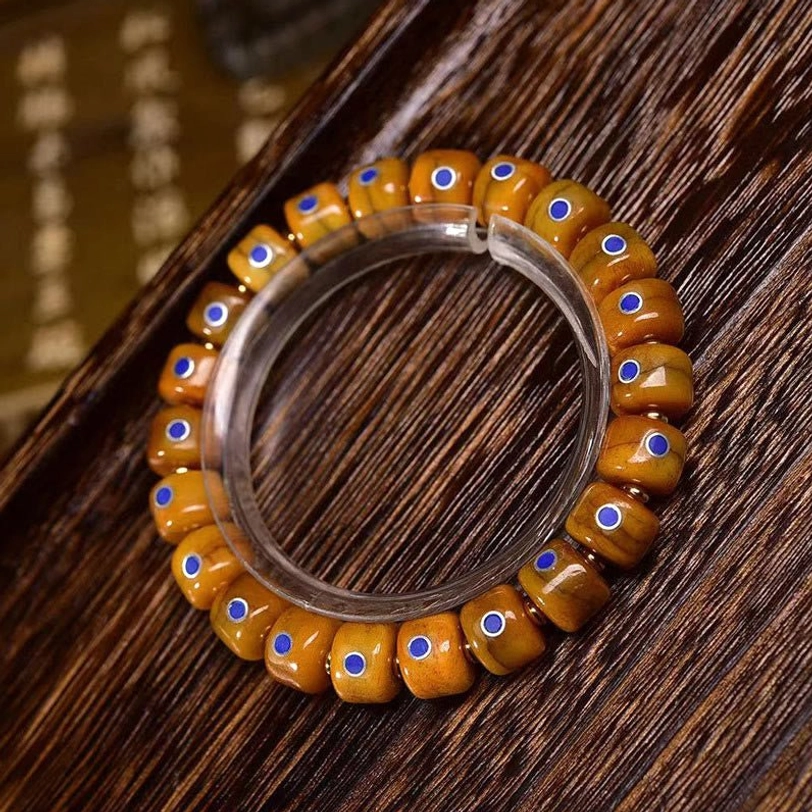 Vintage Tibetan bracelet with blue inlay bone beads mounted on display stand