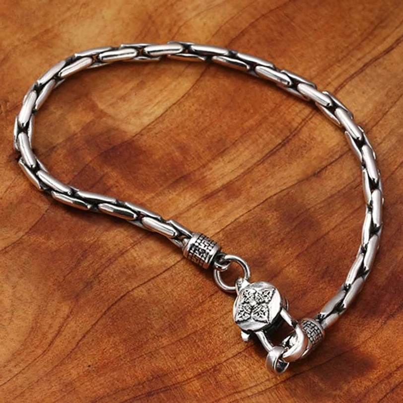 Tibetan engraved silver bracelet with round carved charm and antique silver chain detail