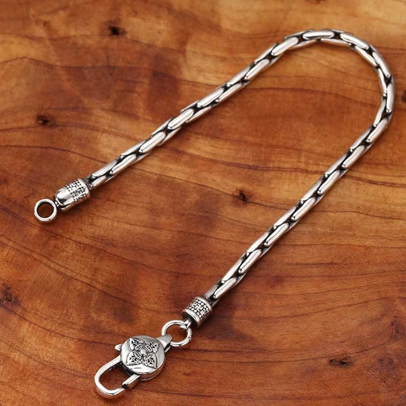 Unfolded tibetan silver bracelet chain showing linked construction and decorative bead