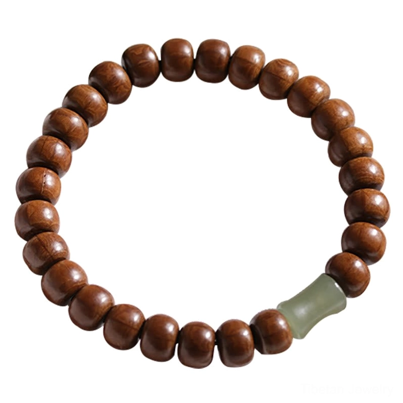 Complete Tibetan protection bracelet loop with round wooden beads and light green jade spacer on warm background