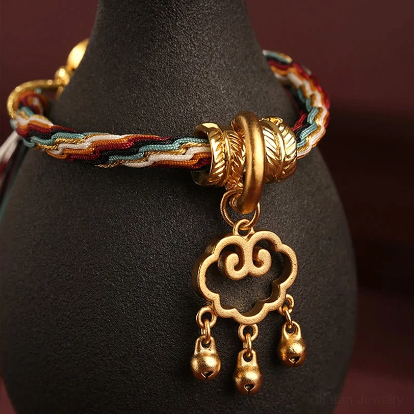Dunhuang deer bracelet on black jewelry display stand showing thick gold metal clasp and hollow cloud lock with bells