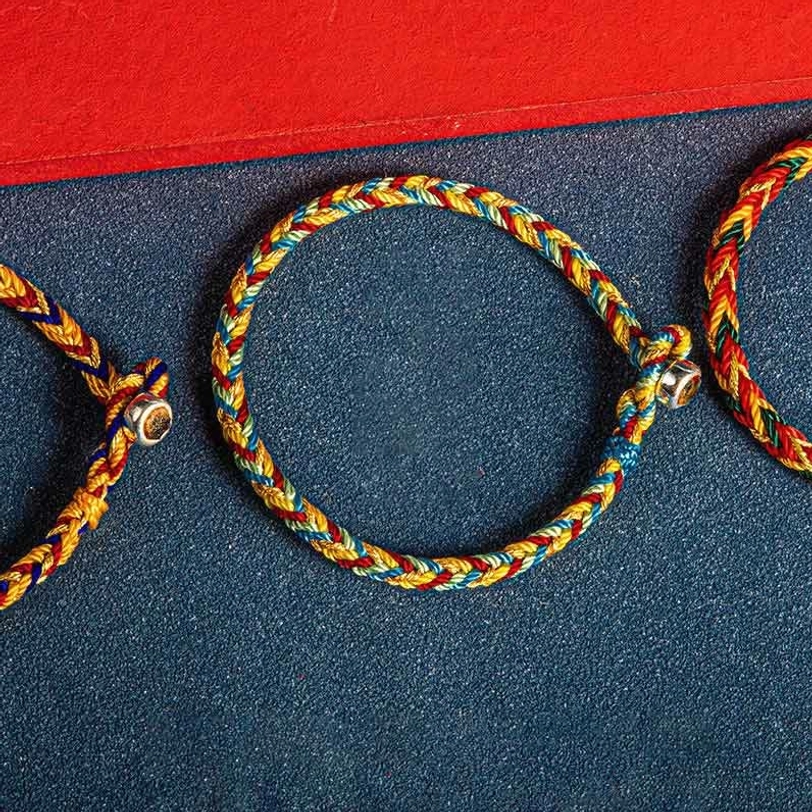 Partial view of Tibetan lucky bracelets showing braided clasp detail and multicolor threads