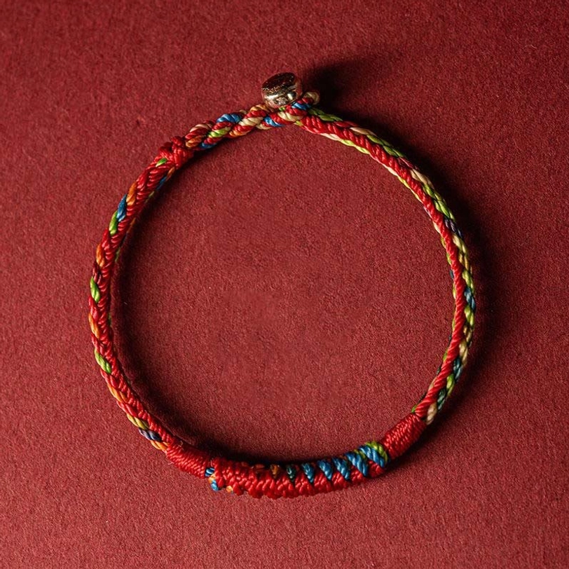 Five-color Tibetan protection bracelet with intricate braided knot detail and metal fastener close-up