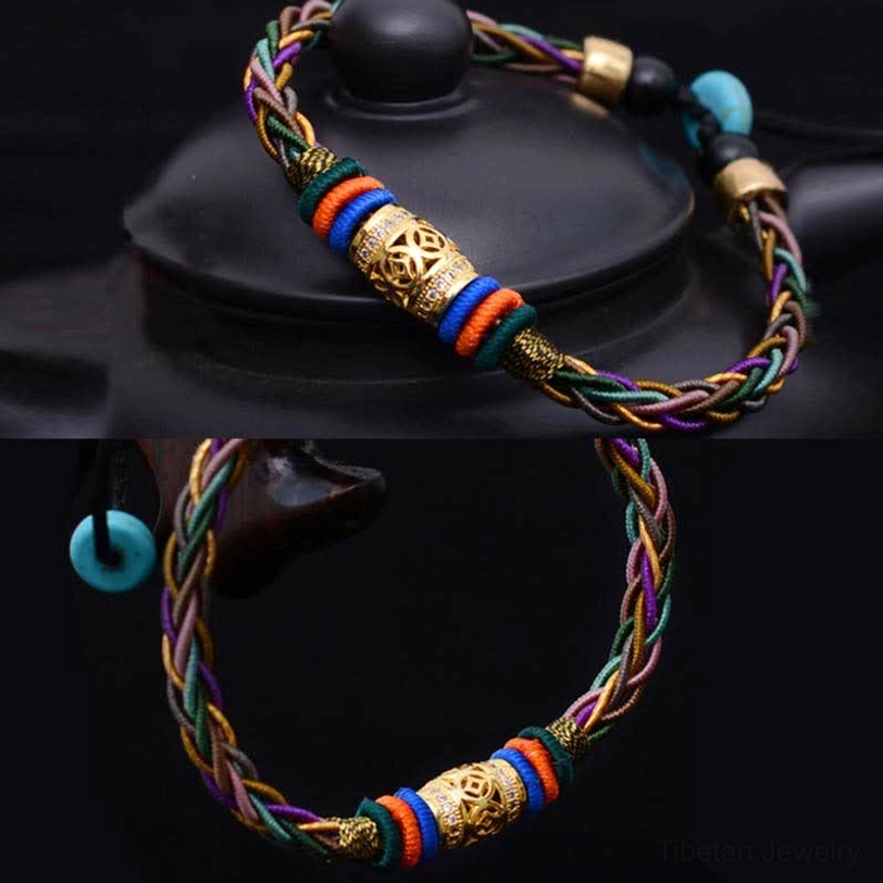 Tibetan woven luck bracelet segments displayed on black ceramic showing multicolor braided rope and gold metal accents in split view