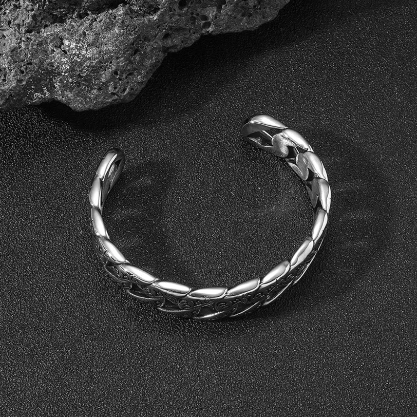 Polished silver titanium cuff bracelet with smooth twisted chain structure, no engraving, side overhead perspective