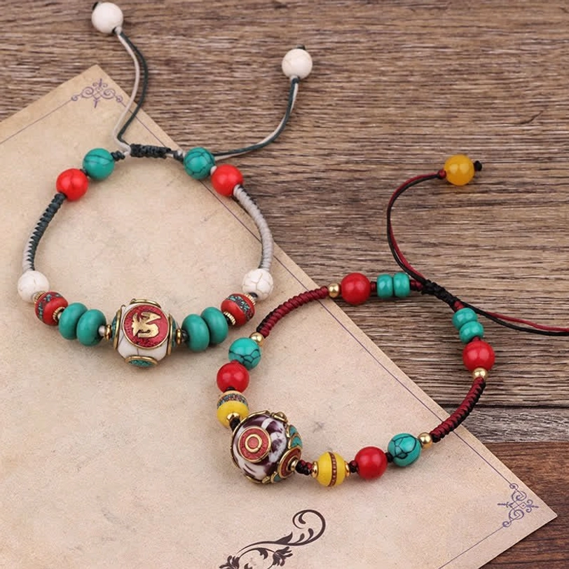 Tibetan braided rope bracelet featuring turquoise amber and protective gemstones close-up