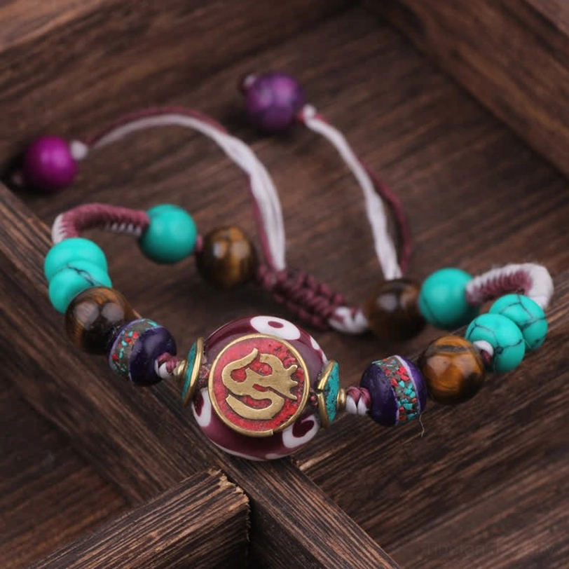 White purple braided rope Tibetan bracelet with healing gemstone beads wooden tray display