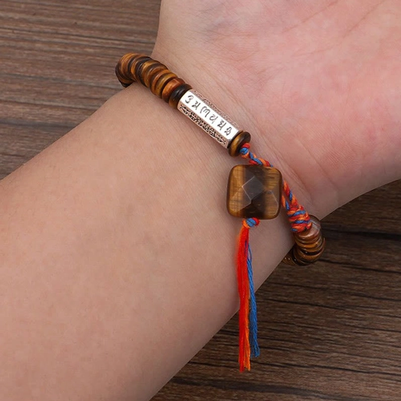 Tibetan tiger eye bracelet worn on wrist showing square tiger eye pendant and natural striped beads fit