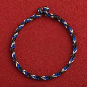 Handwoven Tibetan protection bracelet overhead view three-color rope knot closure detail