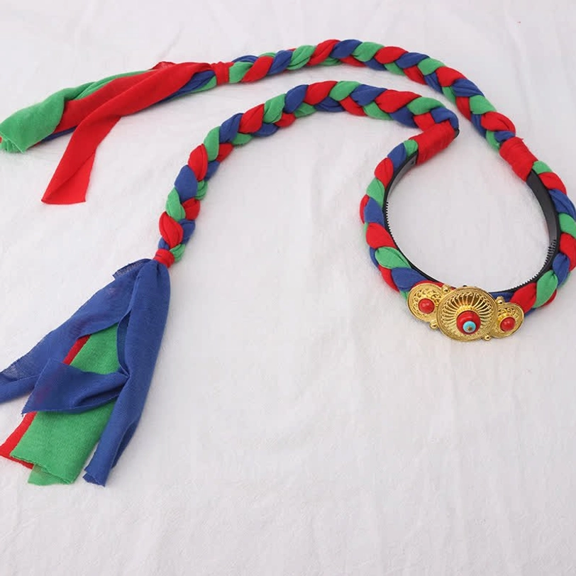 Traditional Tibetan braided hair band with red green blue woven design, fabric tassels and gold charm buckle