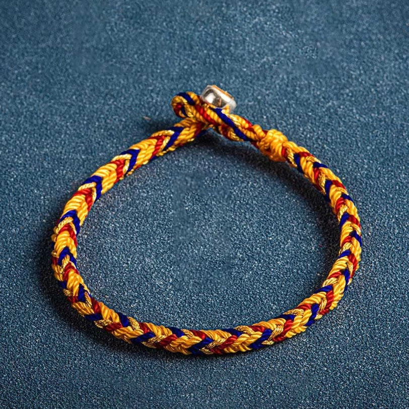 Handcrafted Tibetan lucky bracelet showing braided rope texture metal buckle and multicolor threads close-up