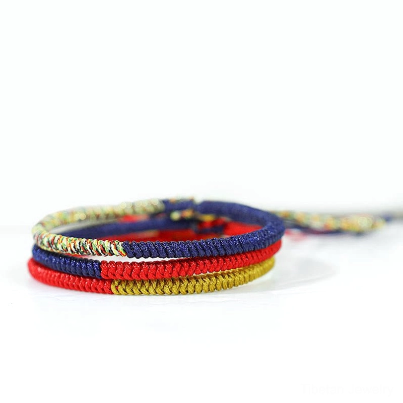 Set of two Tibetan faith protection bracelets stacked together showing multicolor braided texture detail