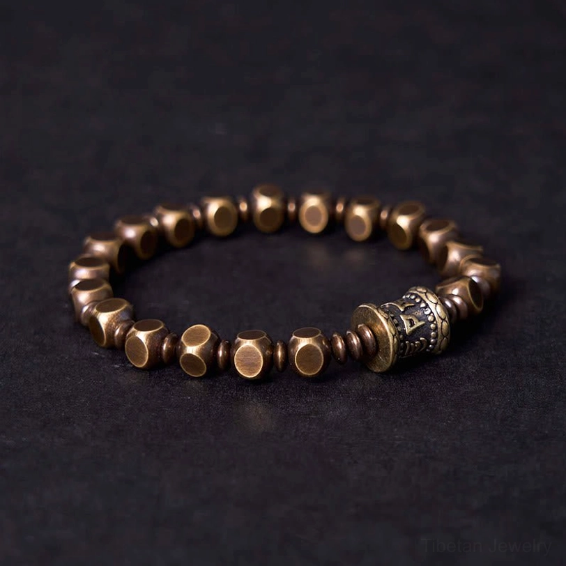 Handcrafted brass spiritual bracelet with carved prayer beads and vintage silver prayer wheel pendant
