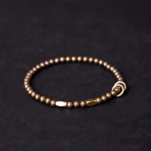 Handcrafted brass beaded bracelet side view showing uniform small round beads and bar toggle clasp detail