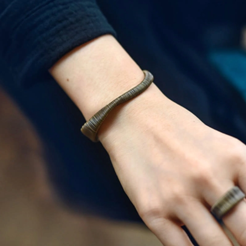 Adjustable Tibetan brass cuff bracelet in vintage bronze finish showing patina and natural aging characteristics