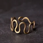 Tibetan curved brass prosperity ring adjustable band front view close-up antique bronze finish