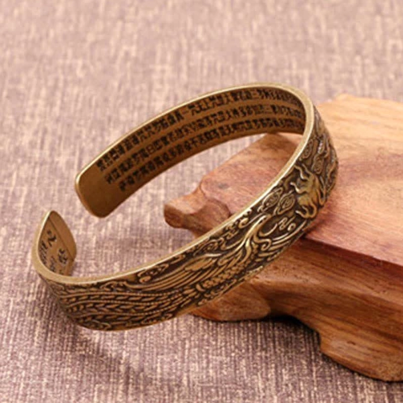 Antique bronze Tibetan cuff bracelet with engraved Buddhist text and phoenix motifs