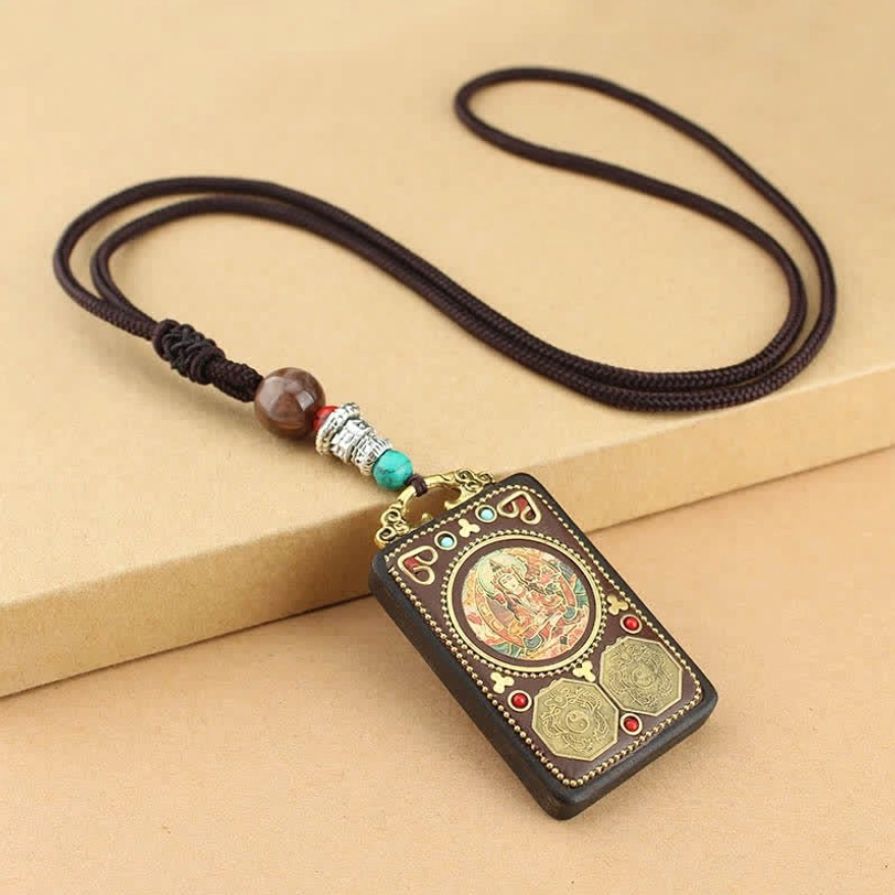 Tibetan amulet pendant necklace with round buddha artwork, brass coins and turquoise bead decoration