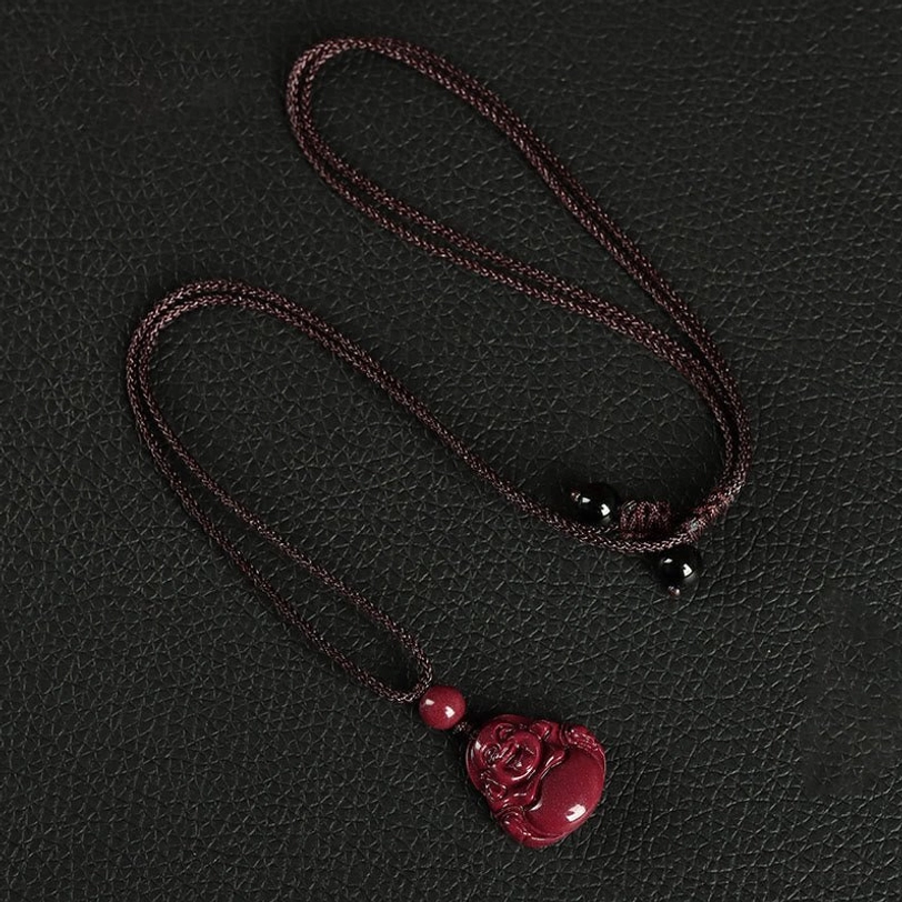 Tibetan cinnabar Buddha pendant necklace in deep red with woven brown rope and decorative beads