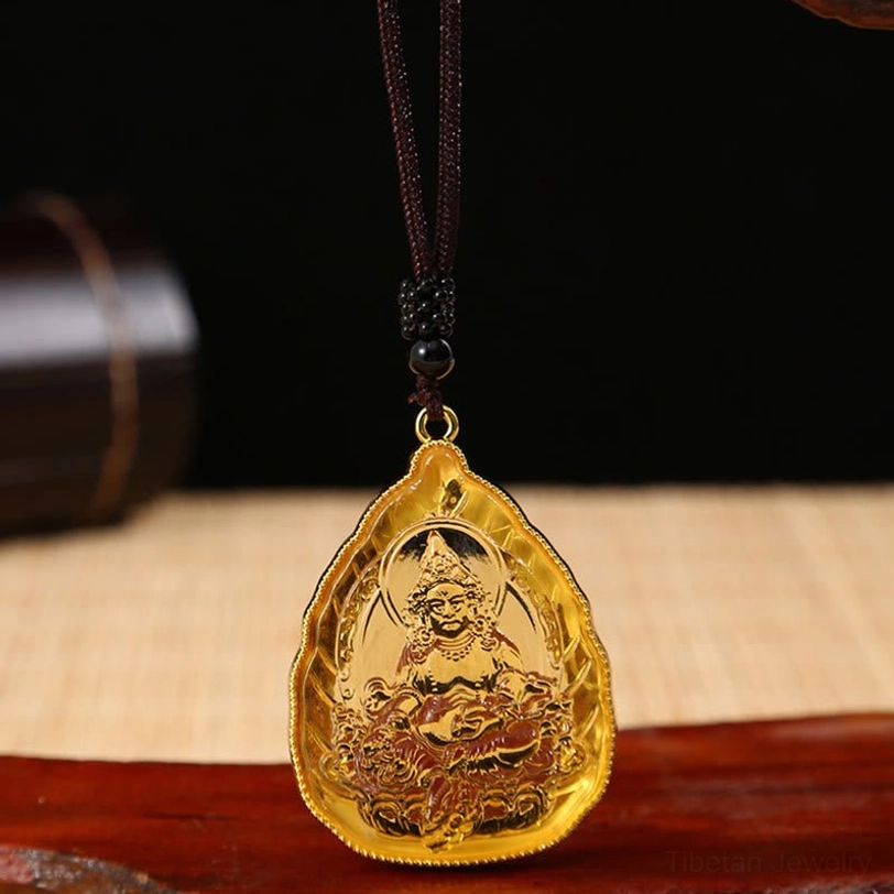 Single golden Tibetan Buddha crystal pendant with intricate engraving and black beaded necklace cord