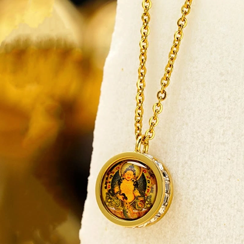 Tibetan Buddha statue pendant necklace featuring printed deity image with crystal-trimmed gold frame on display stand