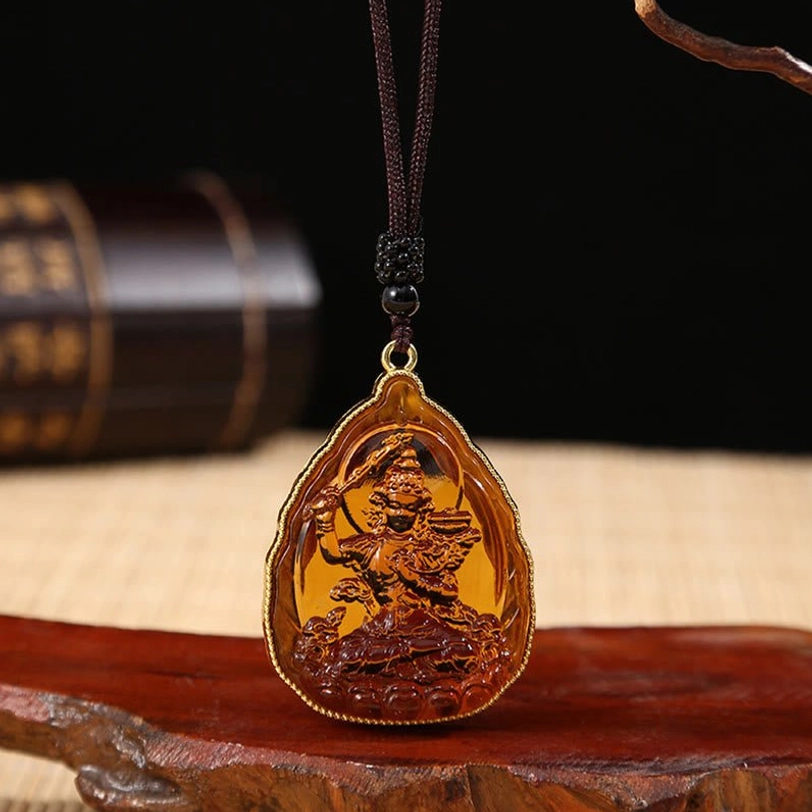 Vibrant orange Buddha crystal pendant with handcrafted engraving and traditional Tibetan styling