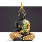 Handcrafted Tibetan Buddha resin statue with black matte body and gold-teal embroidered robes in prayer mudra pose, small size 11cm